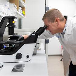 Dr. Younger examining a lab sample.