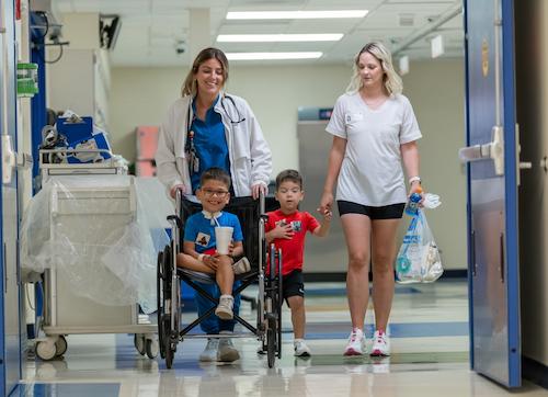 image of patient and family leaving one area of the hospital
