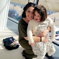 image of a mom and young daughter in front of a large window