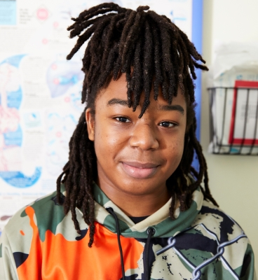 Portrait of a young person wearing a multicolored hoodie
