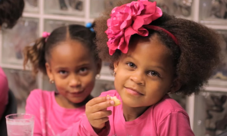 photo of 2 girls both wearing pink shirts