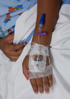 image of a patient's hand with an IV inserted