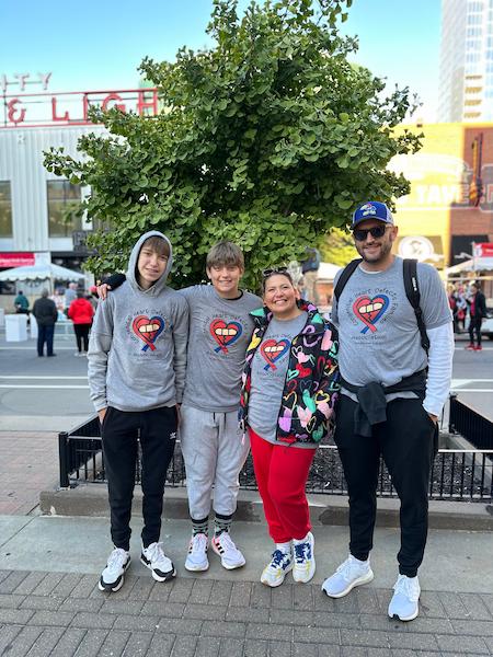 Four family members pose for picture in an outdoor setting