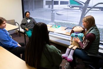 image of new team members participating in clinical orientation in a patient room