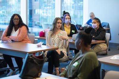 photo of several employees in a conference room engaging in discussion