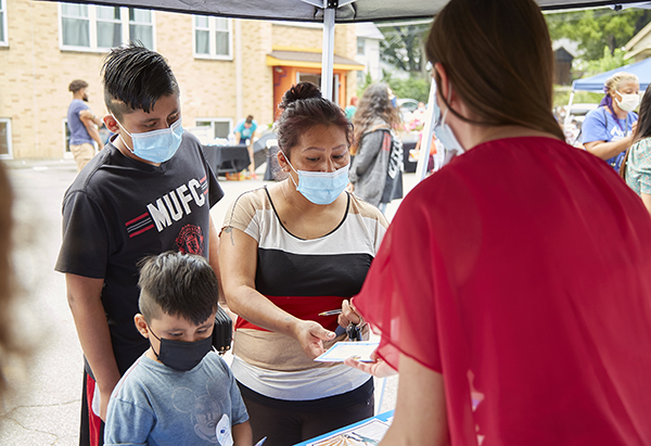 Children's Mercy staff help families at a health care information booth 
