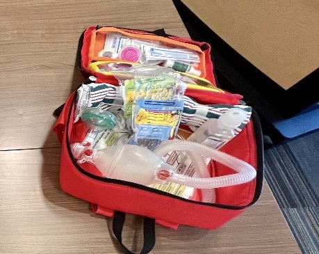 Red emergency tracheostomy go bag containing supplies for children with tracheostomies
