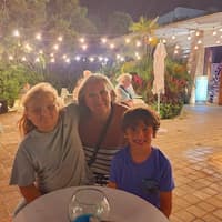 image of parent and two children outside in the early evening