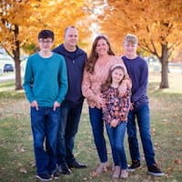 image of family of five posing for a family picture outside in the fall