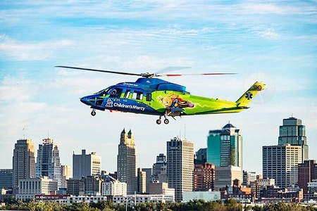 Children's Mercy helicopter flying over the Kansas City skyline.
