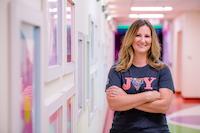 photo of a nurse smiling in a hallway at Children's Mercy