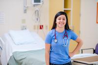photo of a nurse smiling in a patient room