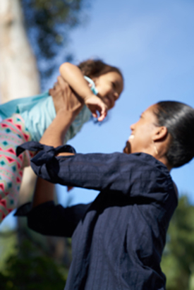 Woman holding child in the air.