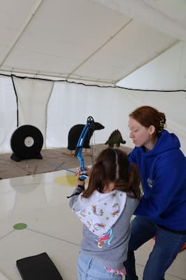 Photo of family enjoying adaptive archery Cerebral Palsy Day activities at Children's Mercy