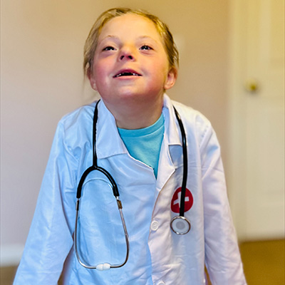 child dressed up as a doctor with a white coat on