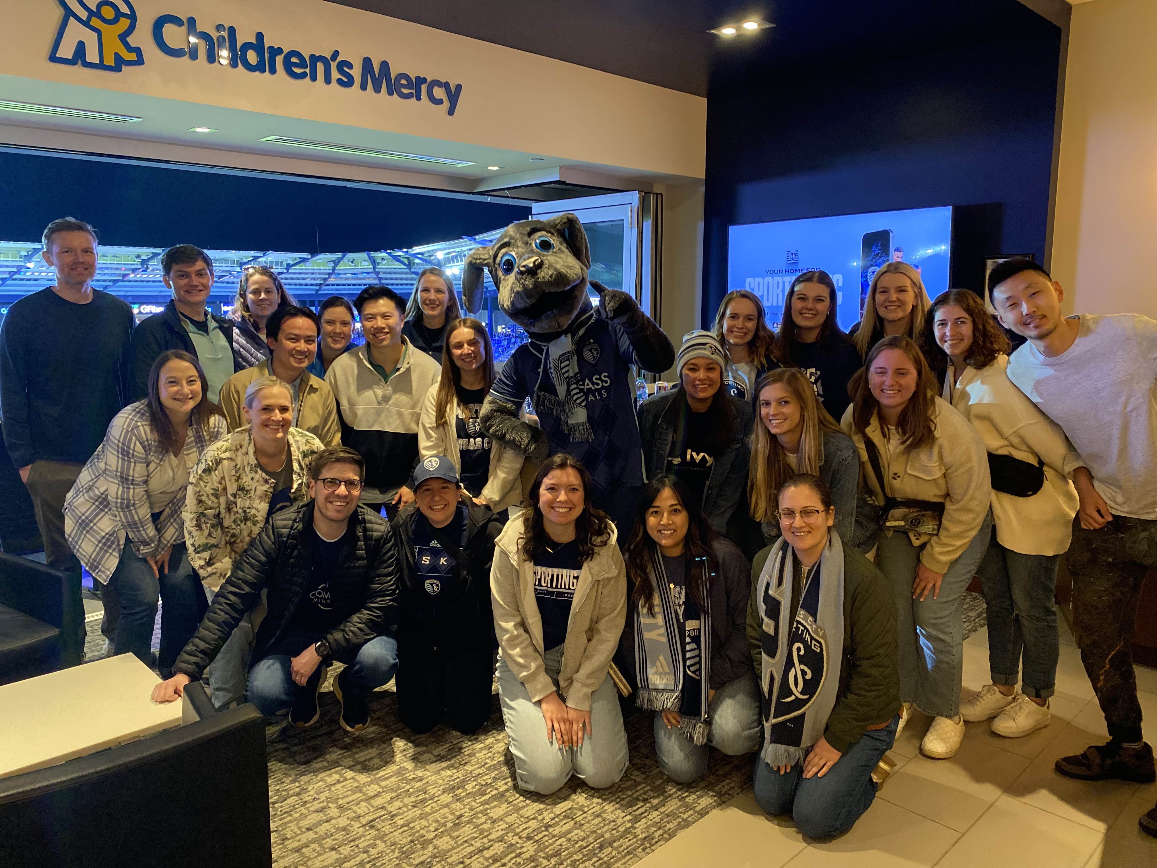 Children’s Mercy team members pose with the Sporting Kansas City mascot during a group outing.