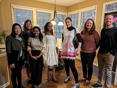 team members gathering in a home for a cultural night event