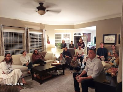 team members gathering in a home for a cultural night event