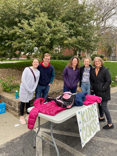 photo of residents participating in local event providing coats to the community