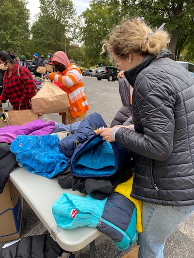 photo of residents participating in local event to provide coats to the community