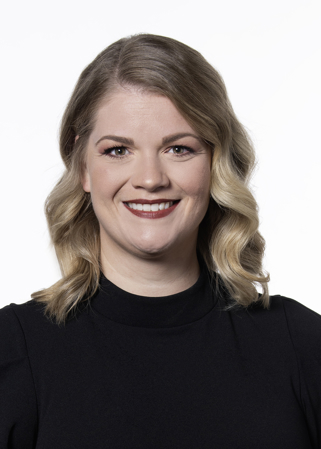 Amanda Matthews. She has blonde hair that falls to her shoulders and is wearing a black shirt.