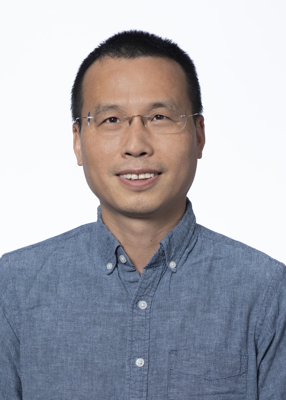 Sheng Xia, vertical photo. He has short black hair and is wearing glasses.
