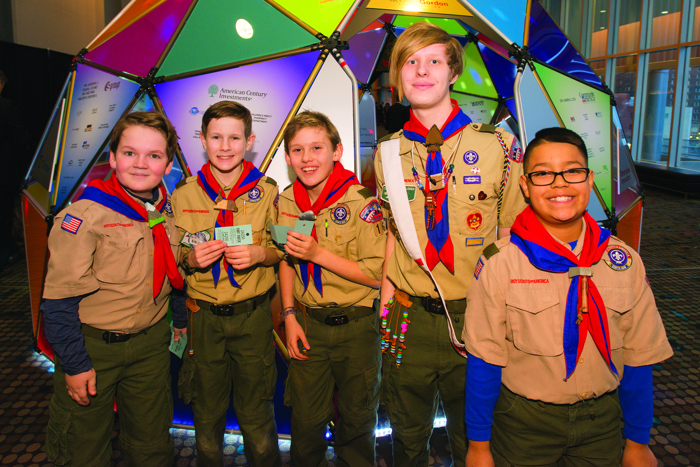 Group of five boy scouts smiling at the camera.